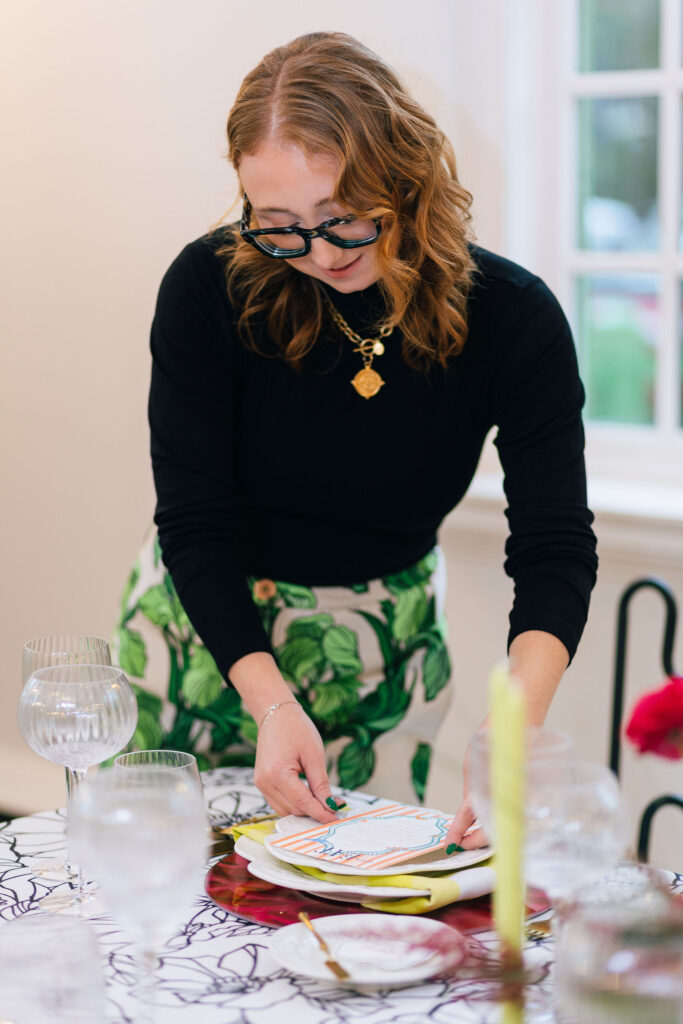 Event planner Baylye Burnette setting a reception table.