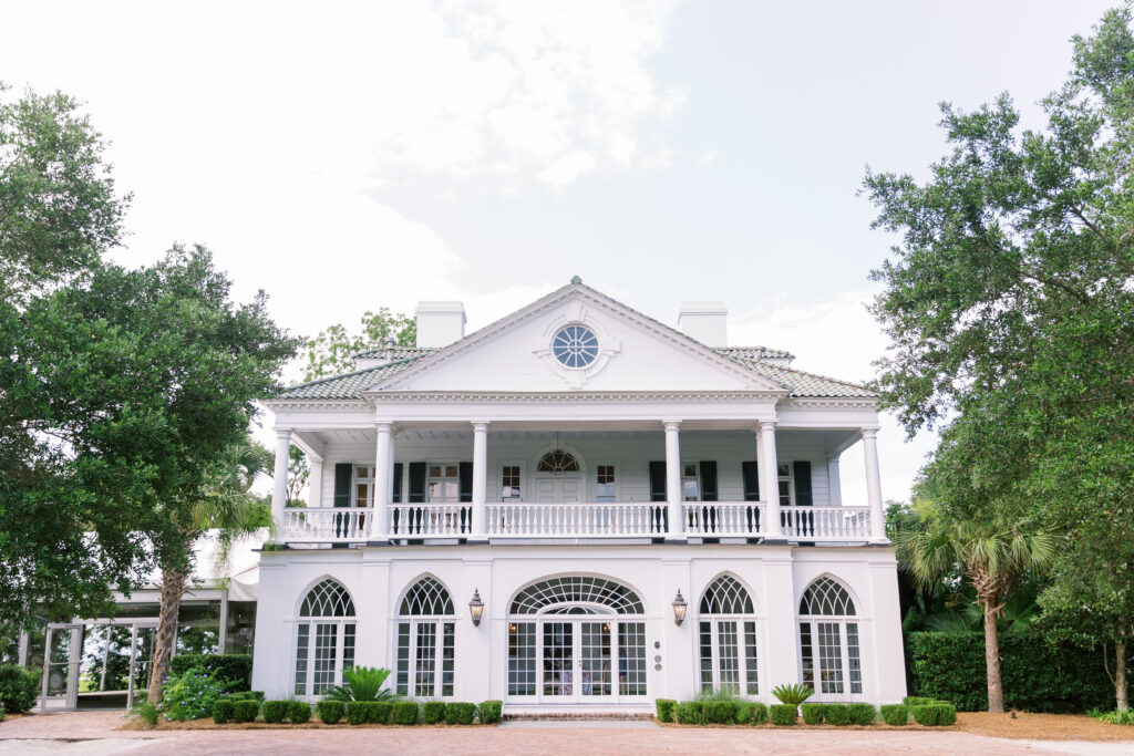 Historic Lowndes Grove venue surrounded by trees.
