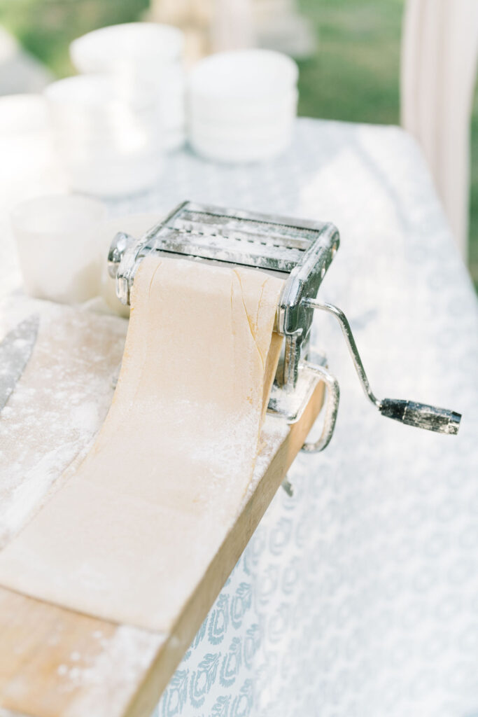 Handmade pasta being rolled at a wedding reception.